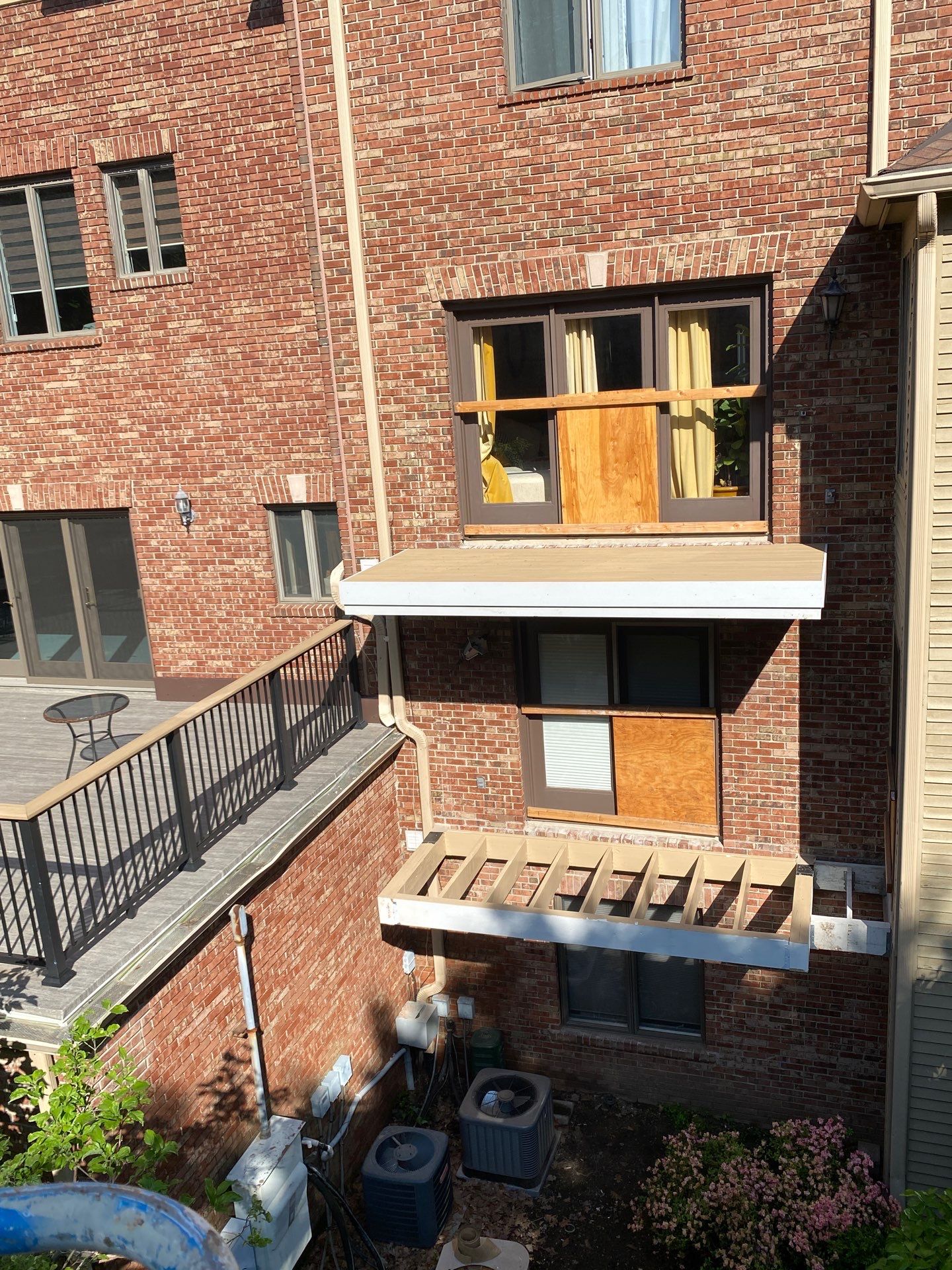 Balcony and exterior deck framing at brick building