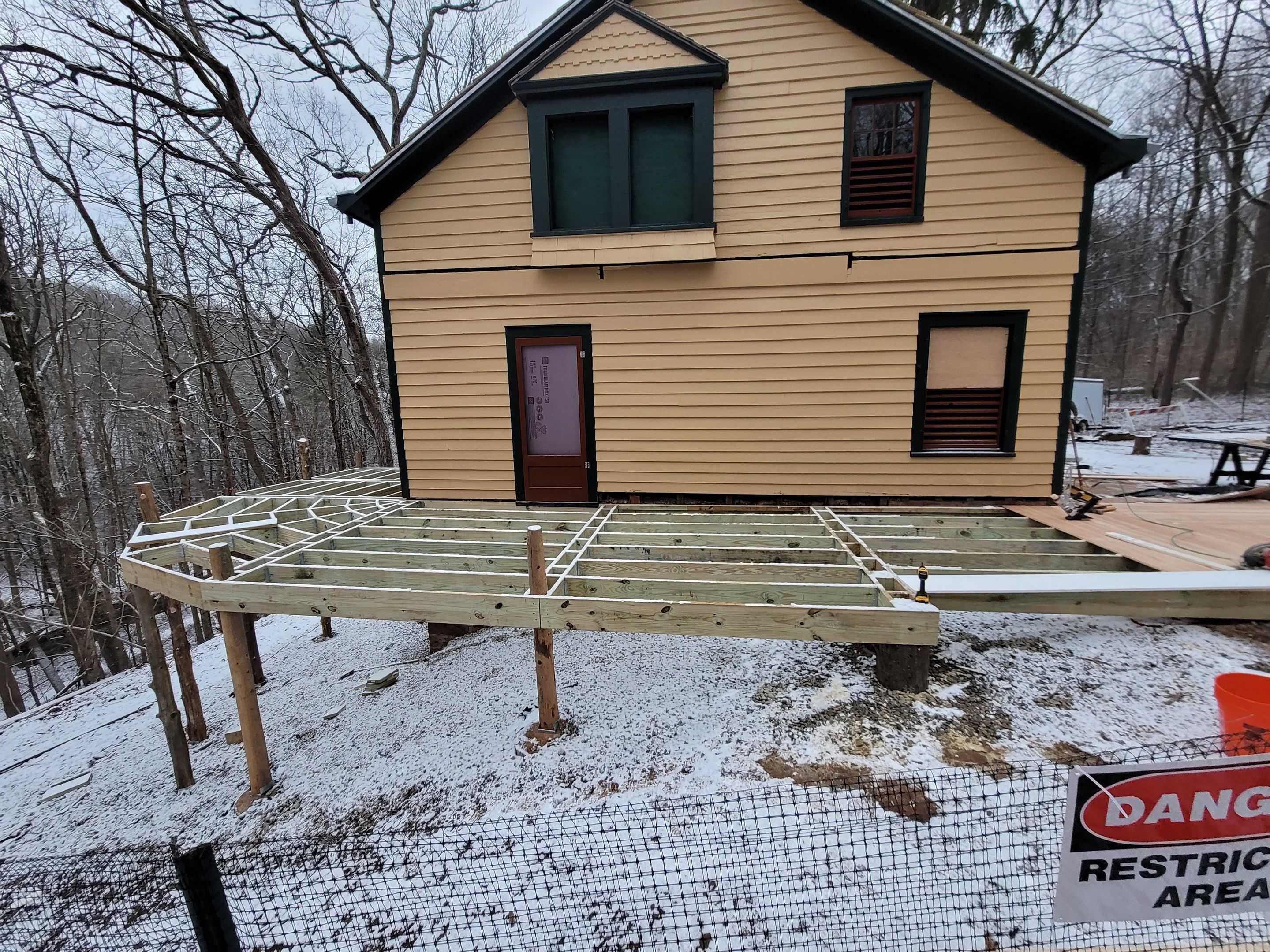 New deck framing and exterior carpentry near house