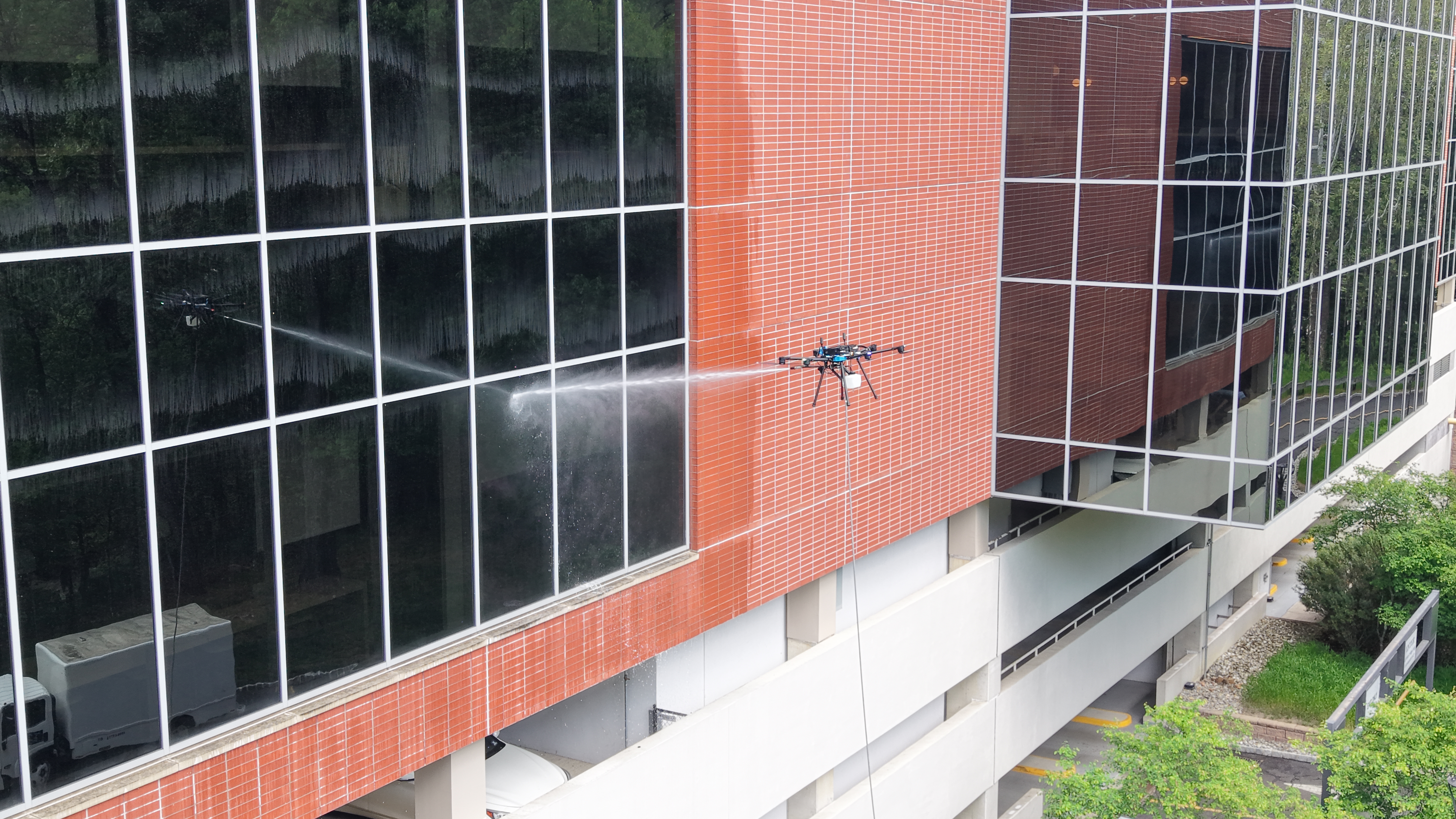 Drone cleaning glass and facade surfaces