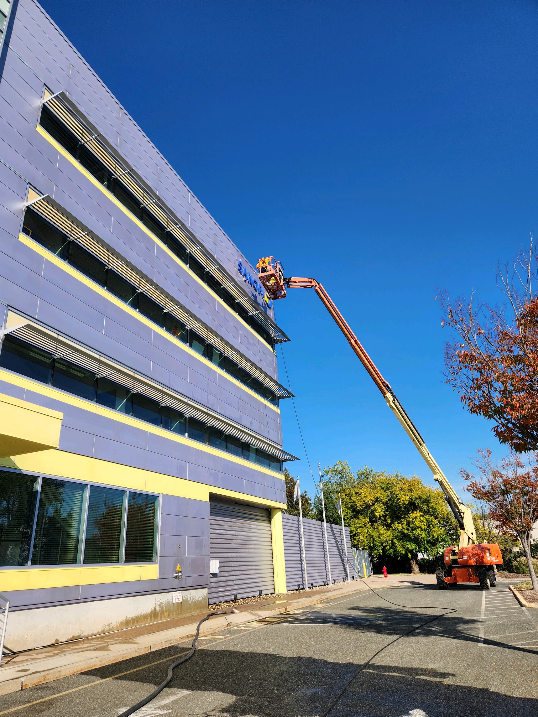 Commercial building exterior cleaning from lift