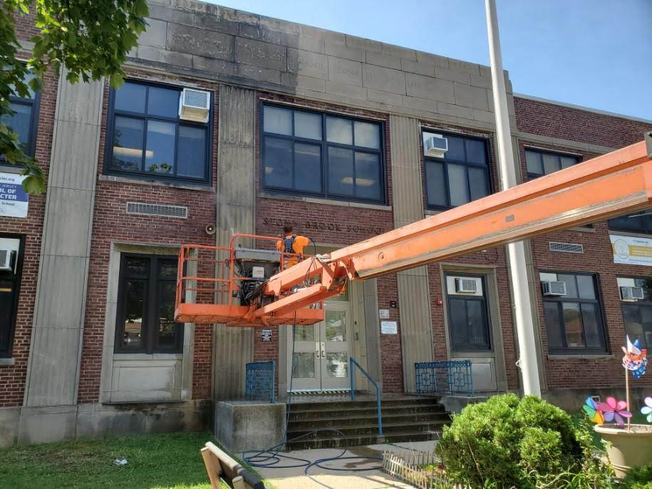 Boom lift cleaning exterior windows and facade