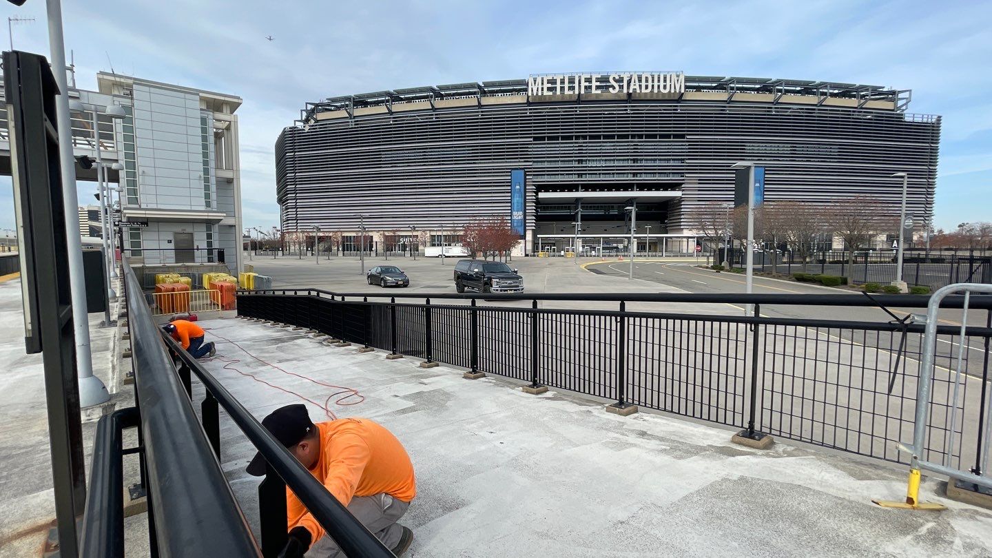 Waterproofing and exterior work near rooftop stadium area