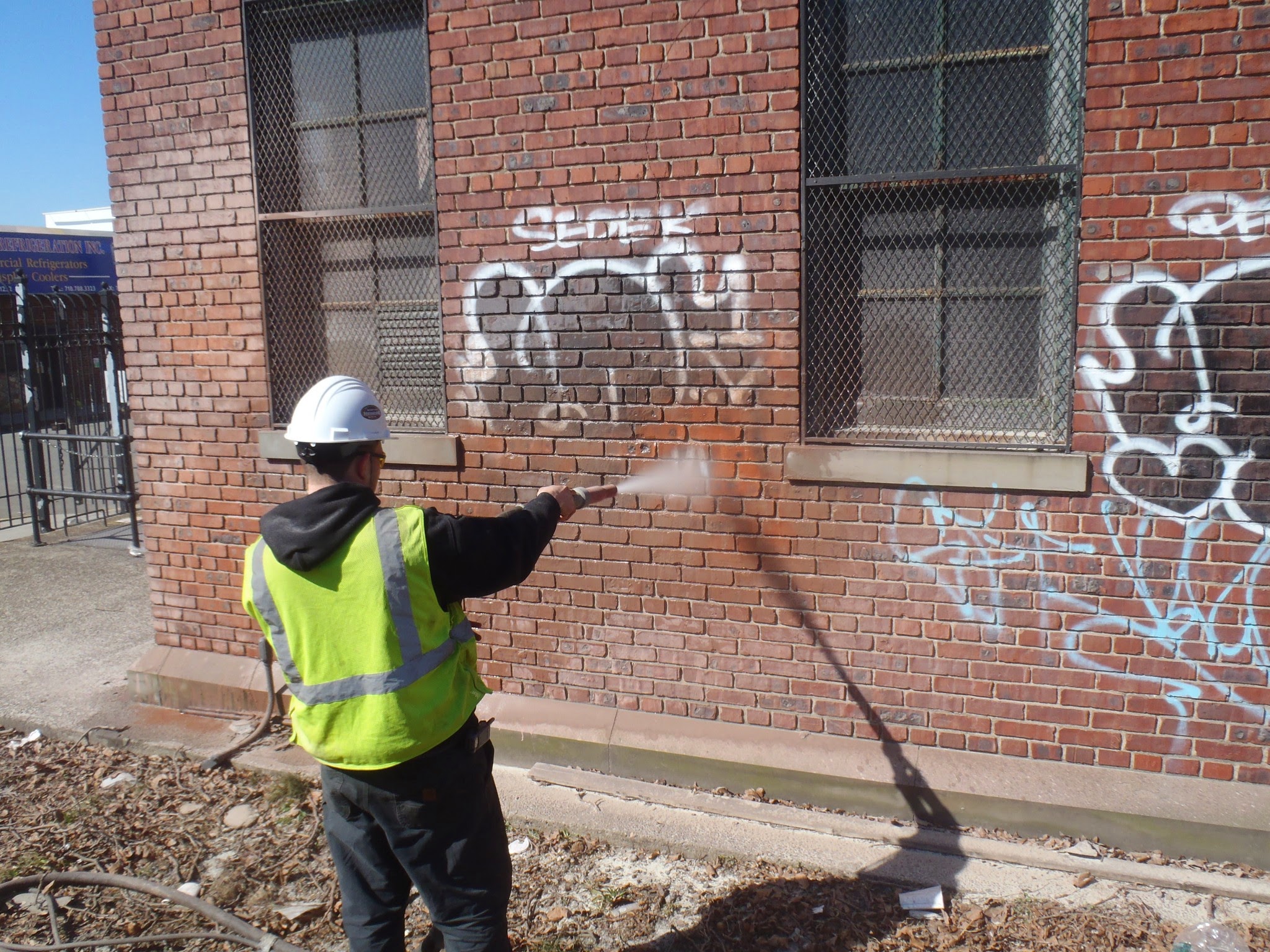 Graffiti removal on brick wall